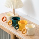 Ceramic cup with a heart - shaped handle