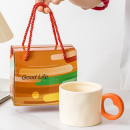 Ceramic cup with a heart - shaped handle