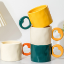 Ceramic cup with a heart - shaped handle
