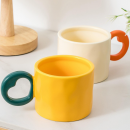 Ceramic cup with a heart - shaped handle