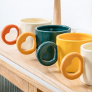 Ceramic cup with a heart - shaped handle